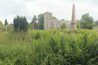 St Oswald's Church Ravenstonedale in background with bracken in foreground