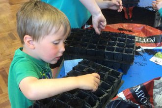 Image of schoolchildren planting wildflower seeds