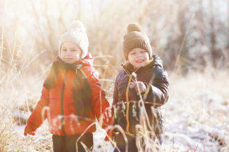 Two children walking through a frosty landscape