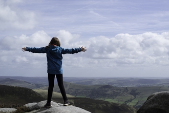 Image of girl on top of mountain