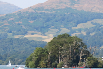 Image of Windermere with boats and fells in background