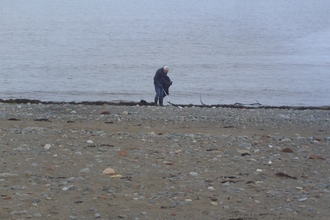 Lone volunteer collecting rubbish