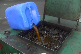 Decanting old oil from a canister found on the beach at the local recycling centre