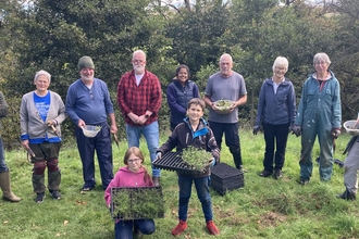 Group of people with plug plants at Edensyde planting day Planting for Pollinators