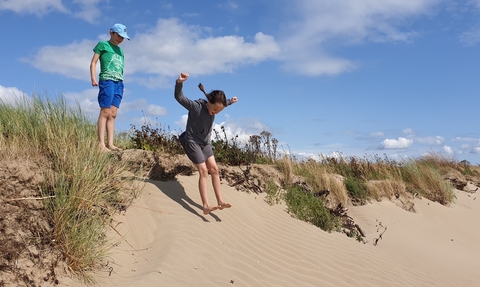 Image of children in sand dunes © Cumbria Wildlife Trust