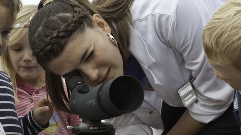 Children being educated about seabirds via a telescope at Scottish Seabird Centre, North Berwick, Scotland © Peter Cairns/2020VISION