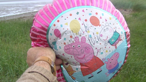 Children's helium balloon washed up on the beach