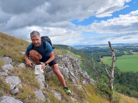 Image of Adam McGinley collecting seeds for seed bank at Gosling Sike credit Cumbria Wildlife Trust