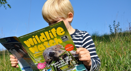 Boy reading Wildlife Watch magazine 2009 credit Emma Bradshaw