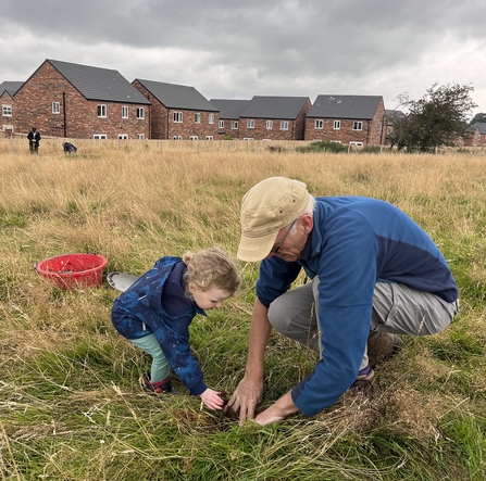 A family helping to plug plant at Cold Springs nature reserve