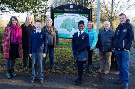 Image of people gathered around noticeboard at Hammonds Pond Carlisle