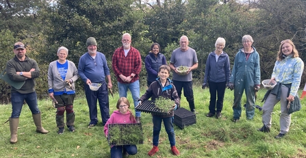 Group of people with plug plants at Edensyde planting day Planting for Pollinators