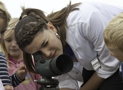 Children being educated about seabirds via a telescope at Scottish Seabird Centre, North Berwick, Scotland © Peter Cairns/2020VISION