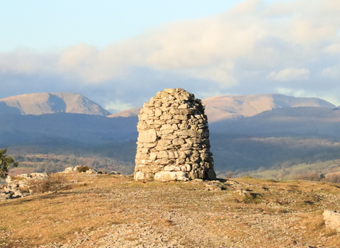 View of The Lake District fells and the cairn on Whitabarrow - Hervey Memorial reserve